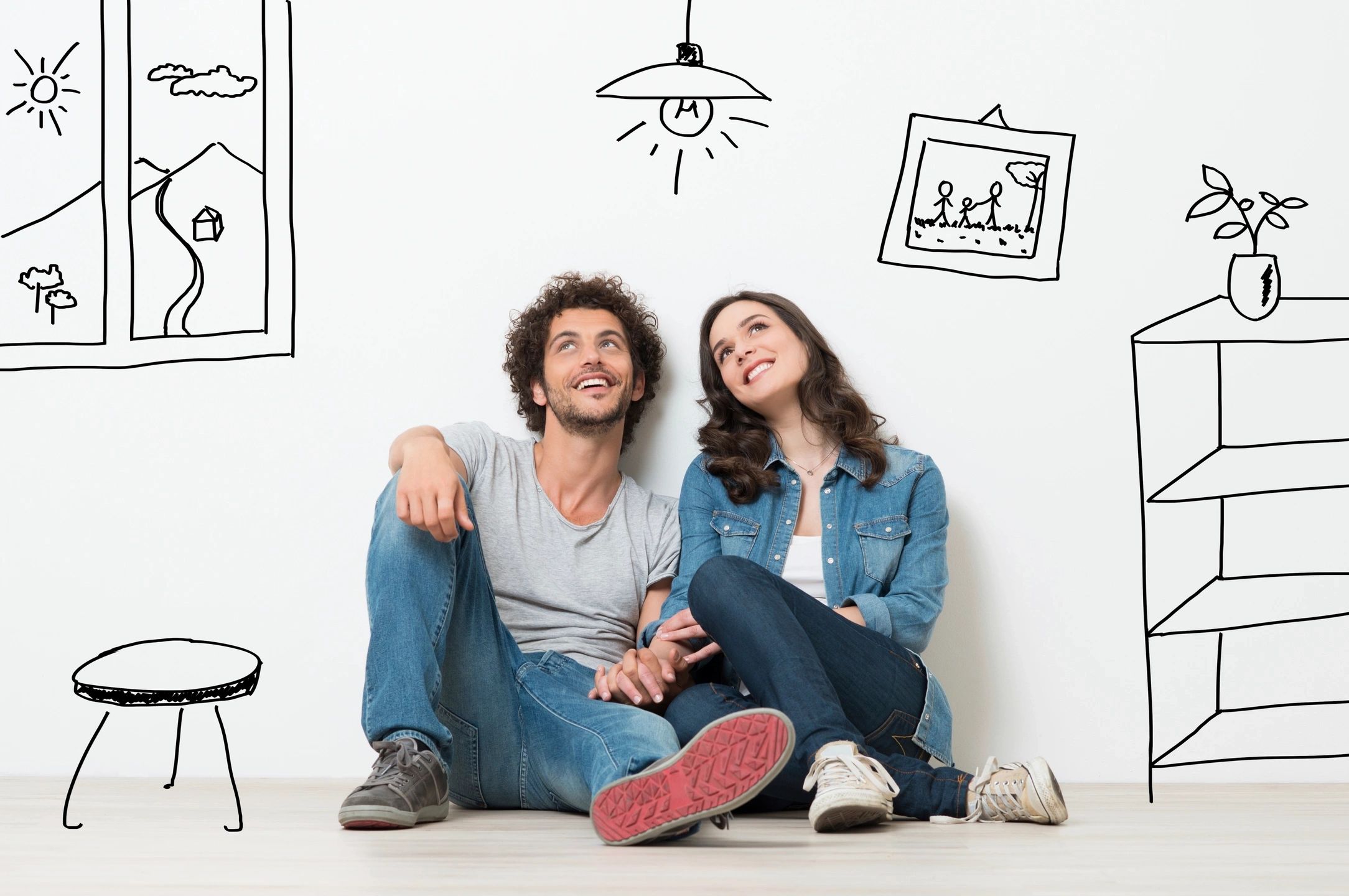 fm=f_1635 A man and woman sitting on the ground in front of wall with drawings.